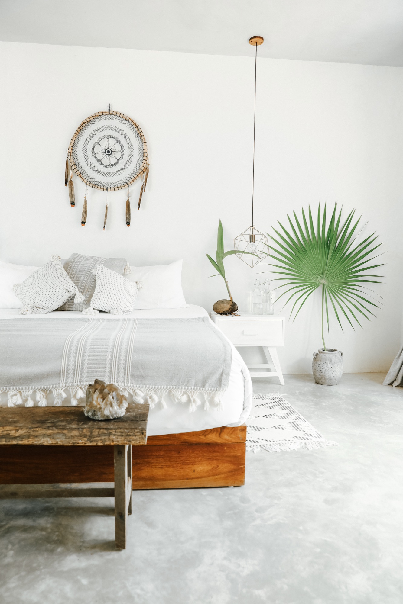 A Sanará bedroom, white linen and a dreamcatcher